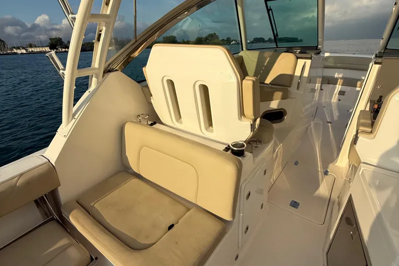 On Pointe Yacht Photos Pics 2016 Pursuit DC 325 Dual Console boat interior with beige seating and ocean view.
