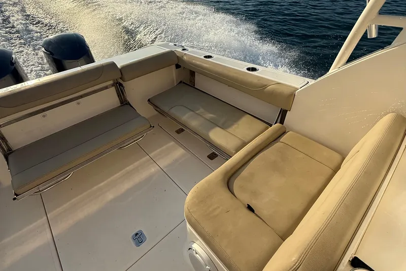On Pointe Yacht Photos Pics 2016 Pursuit DC 325 Dual Console boat interior with beige seating and ocean backdrop.