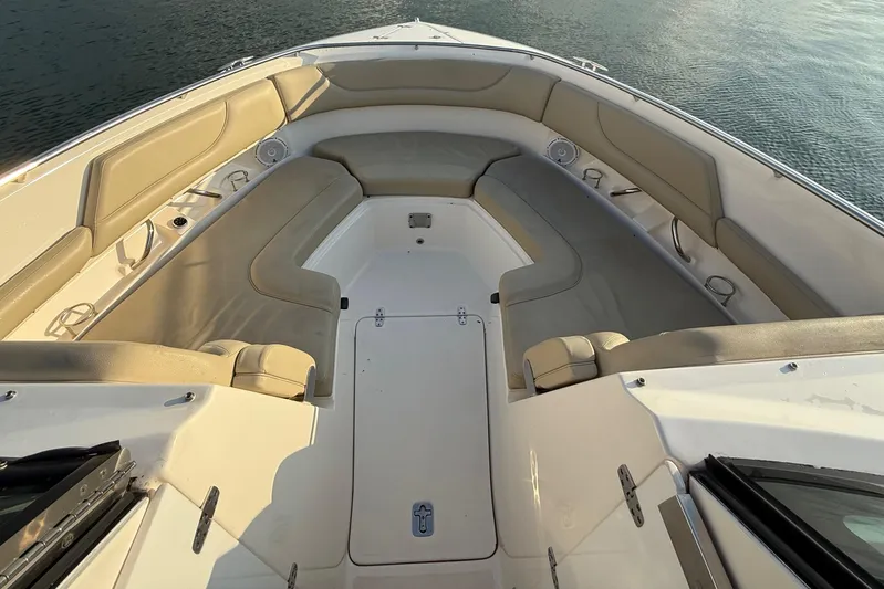 On Pointe Yacht Photos Pics 2016 Pursuit DC 325 Dual Console boat interior with beige seating and storage compartments.