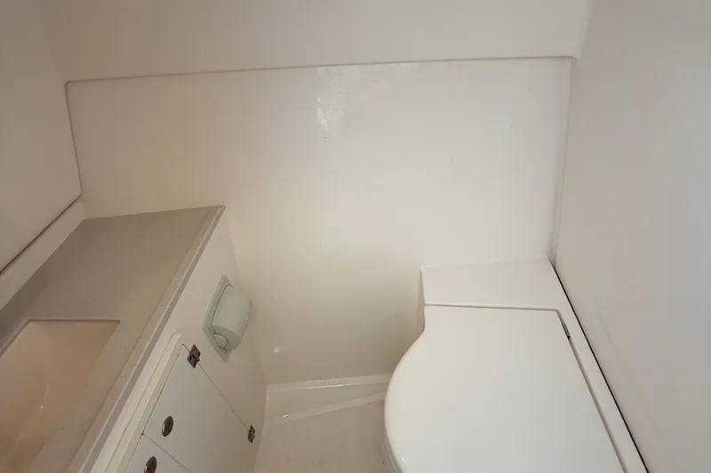 On Pointe Yacht Photos Pics 2016 Pursuit DC 325 Dual Console boat bathroom interior with sink and toilet.