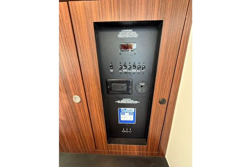 On Pointe Yacht Photos Pics Electrical panel on 2016 Pursuit DC 325 Dual Console boat, featuring switches and outlets.