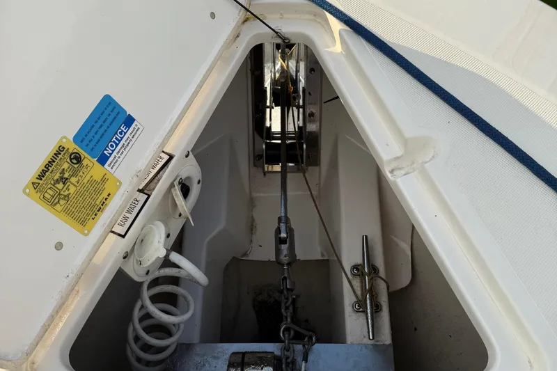 On Pointe Yacht Photos Pics 2016 Pursuit DC 325 Dual Console anchor compartment with warning labels and rope.