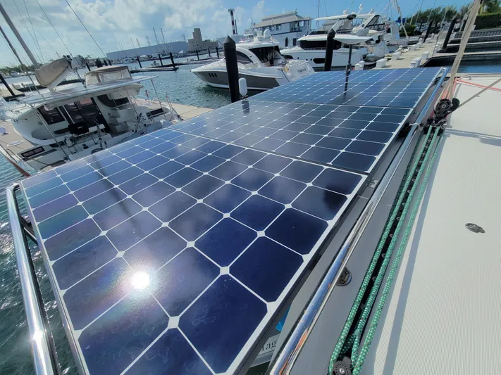 Sugar Magnolia Yacht Photos Pics Solar panels on a 2017 Lagoon 42 catamaran docked at a marina.
