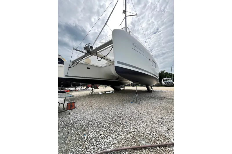 Sugar Magnolia Yacht Photos Pics 2017 Lagoon 42 catamaran on dry dock, cloudy sky background.