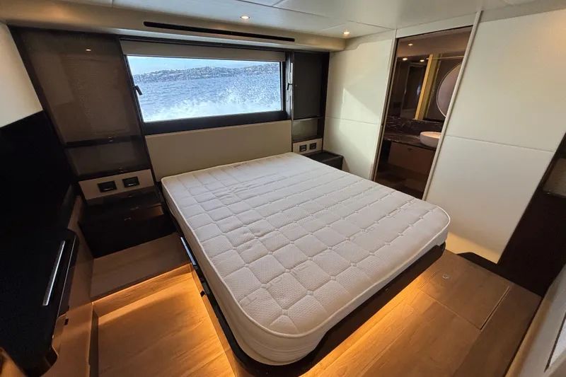  Yacht Photos Pics Luxurious bedroom interior of 2023 Absolute 60 Fly yacht with ocean view.