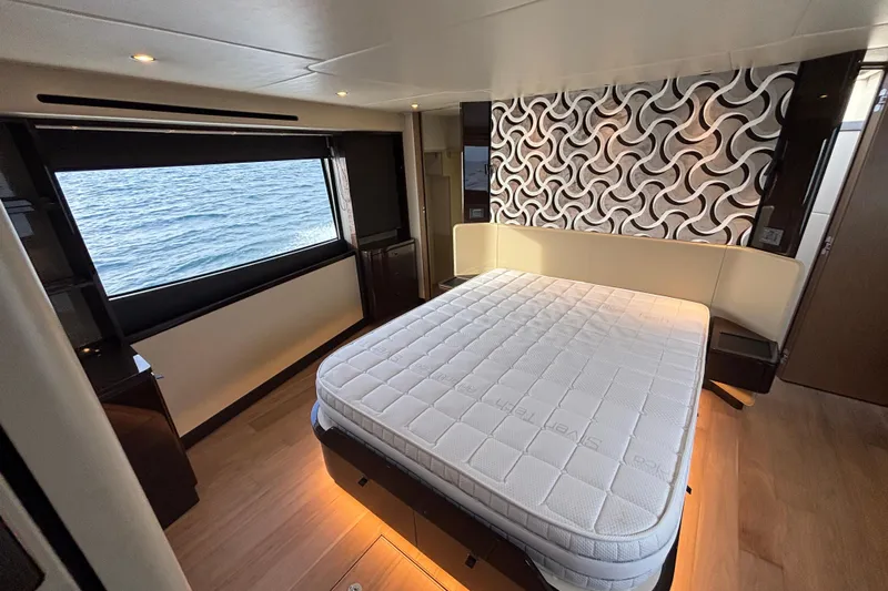  Yacht Photos Pics Luxurious bedroom interior of 2023 Absolute 60 Fly yacht with ocean view.