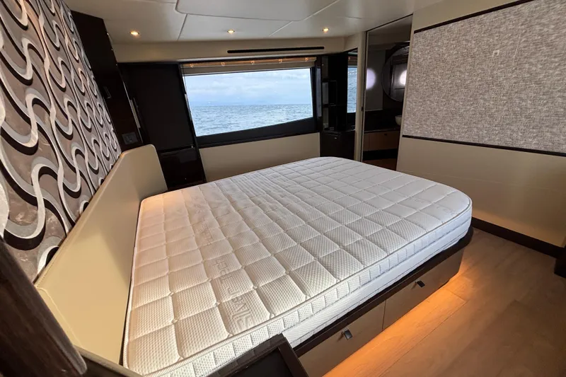  Yacht Photos Pics Luxurious bedroom interior of 2023 Absolute 60 Fly yacht with ocean view.