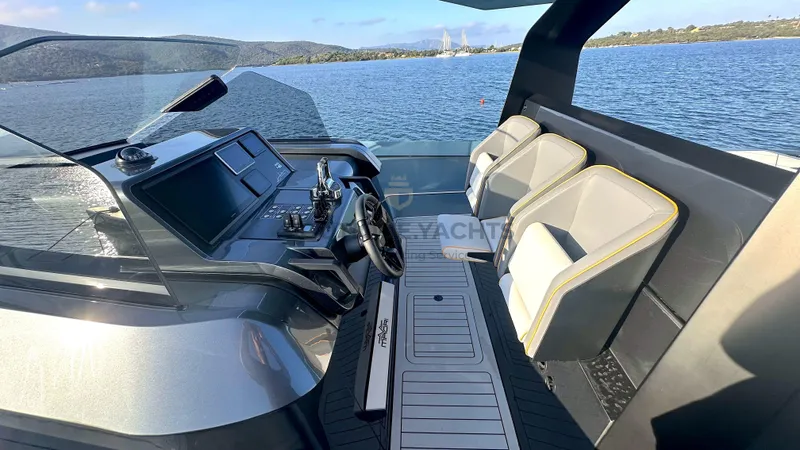 Hull #5 Yacht Photos Pics 2024 Maori 46ft yacht cockpit with modern controls and seating on a serene lake.