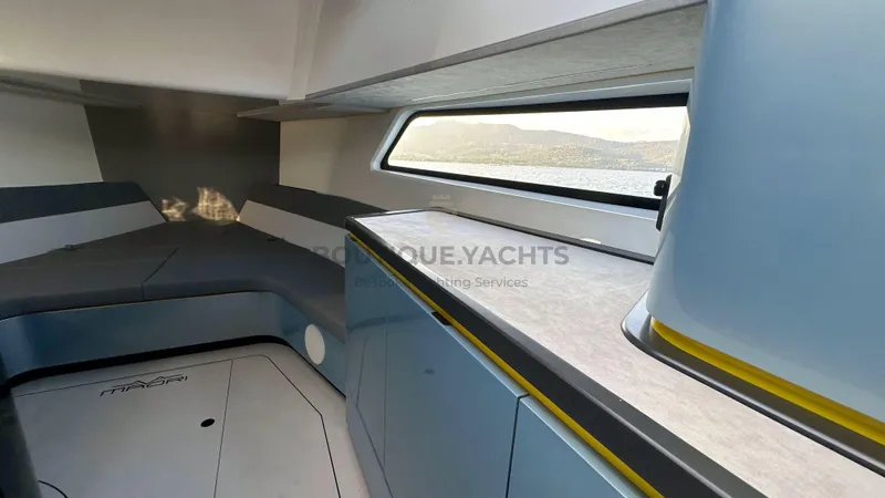 Hull #5 Yacht Photos Pics Modern interior of 2024 Maori 46ft yacht with sleek design and panoramic window view.