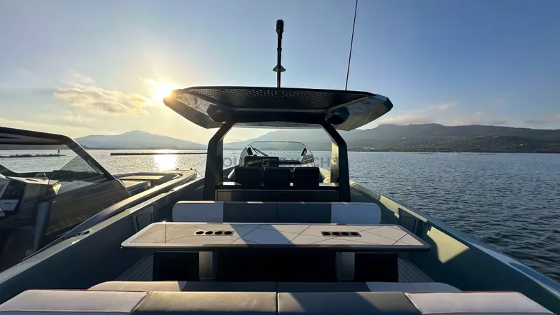 Hull #5 Yacht Photos Pics 2024 Maori 46ft yacht on serene water at sunset, featuring modern design and spacious deck.