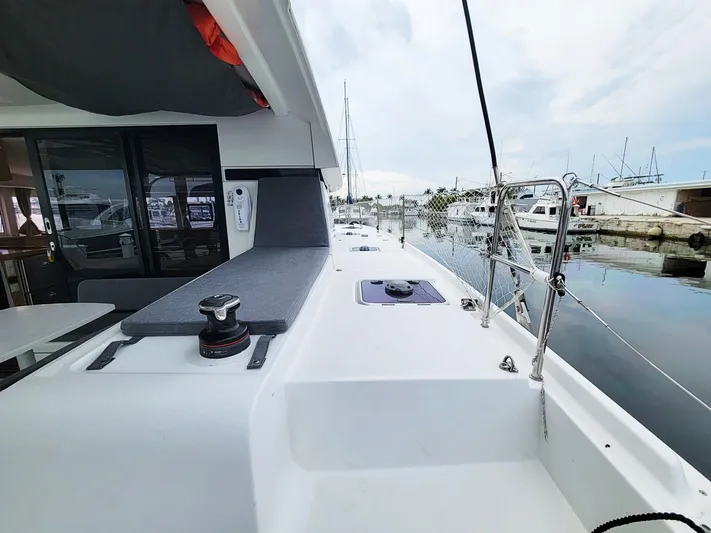 Sugar Magnolia Yacht Photos Pics 2017 Lagoon 42 catamaran docked at a marina, featuring a spacious deck and modern design.