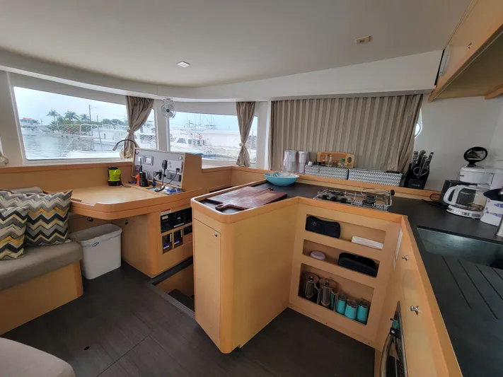 Sugar Magnolia Yacht Photos Pics Interior of 2017 Lagoon 42 catamaran with modern kitchen and navigation area.