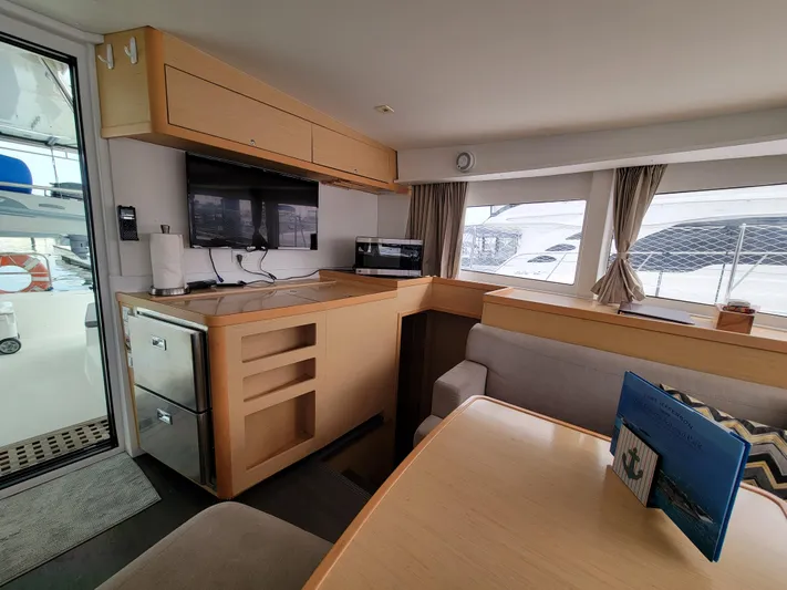 Sugar Magnolia Yacht Photos Pics Interior of 2017 Lagoon 42 catamaran with modern kitchen and dining area.