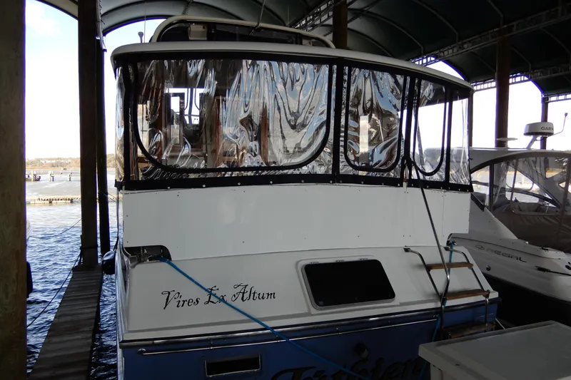  Yacht Photos Pics 1989 Jefferson 46 Sundeck yacht docked in a covered marina.