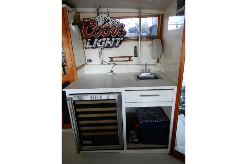  Yacht Photos Pics 1989 Jefferson 46 Sundeck boat interior with sink, mini fridge, and Coors Light sign.