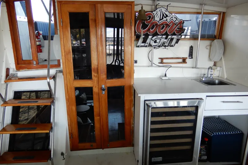  Yacht Photos Pics 1989 Jefferson 46 Sundeck interior with wooden doors, kitchenette, and Coors Light sign.