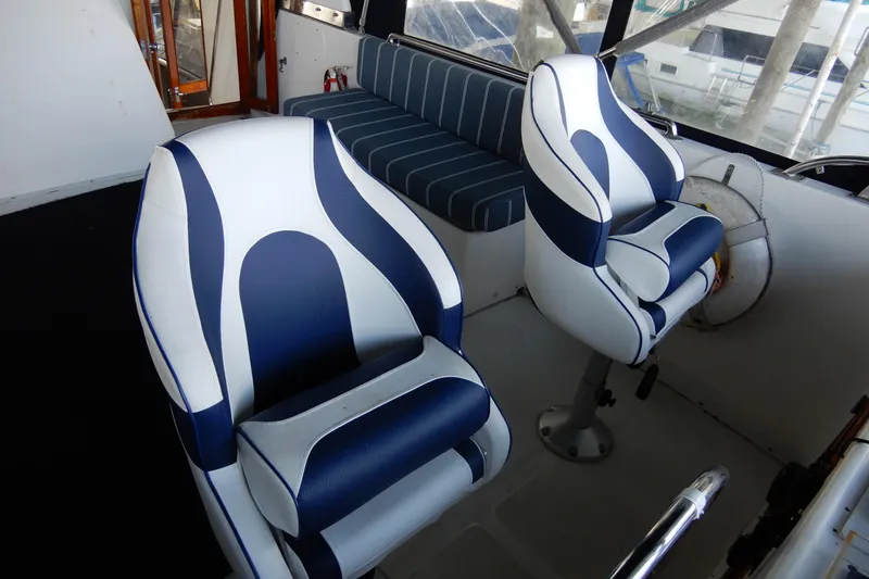  Yacht Photos Pics Interior of 1989 Jefferson 46 Sundeck with blue and white seating.
