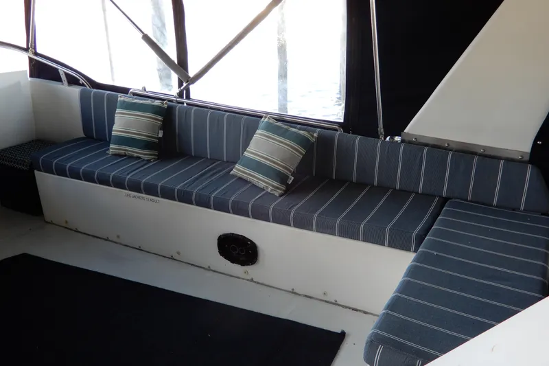  Yacht Photos Pics 1989 Jefferson 46 Sundeck interior with striped seating and cushions.