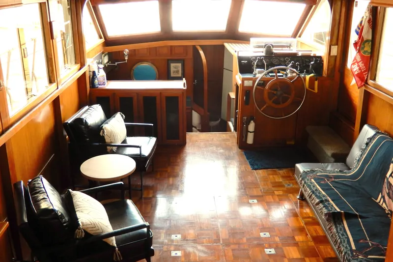  Yacht Photos Pics 1989 Jefferson 46 Sundeck interior with wooden decor, leather seating, and steering wheel.