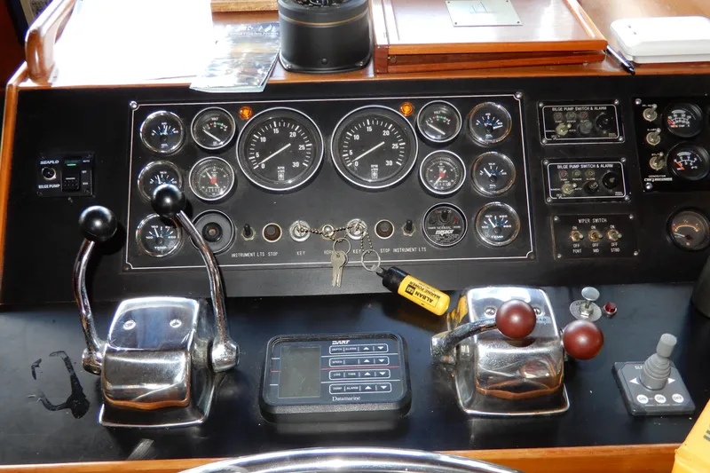  Yacht Photos Pics Control panel of a 1989 Jefferson 46 Sundeck boat with gauges and levers.