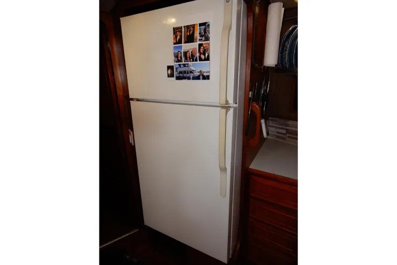  Yacht Photos Pics White refrigerator with photos, inside a 1989 Jefferson 46 Sundeck yacht kitchen.