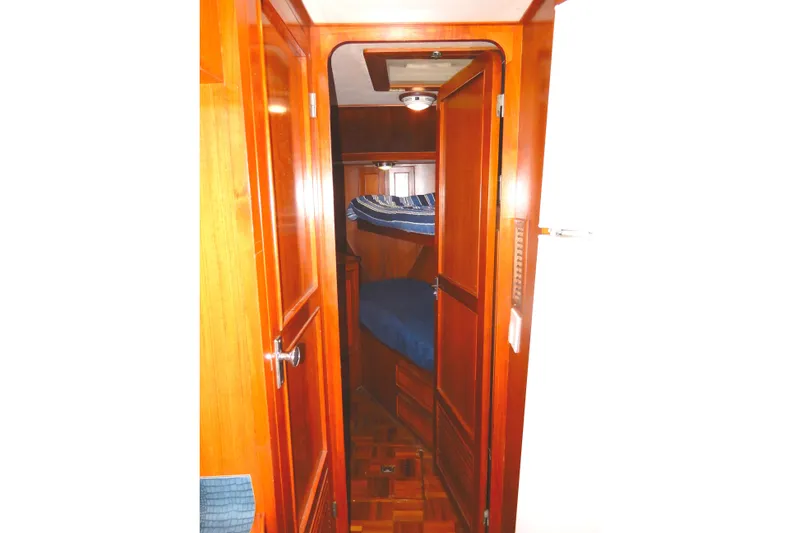  Yacht Photos Pics 1989 Jefferson 46 Sundeck interior with wooden finish and bunk beds.