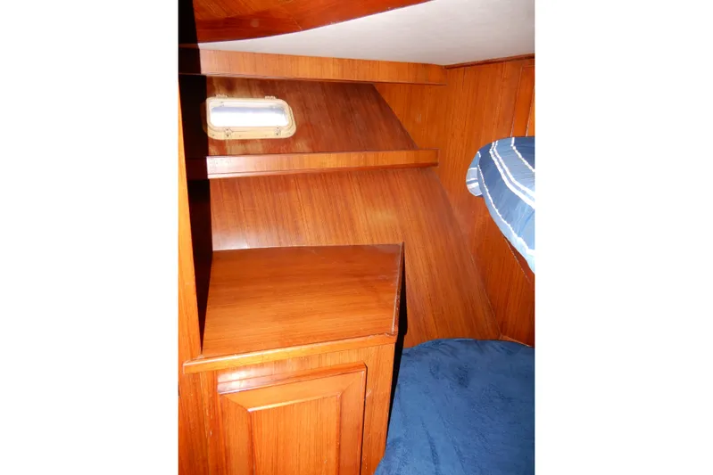  Yacht Photos Pics Interior of 1989 Jefferson 46 Sundeck yacht with wooden cabinetry and blue carpet.