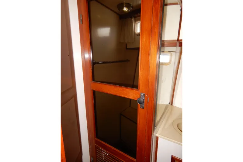  Yacht Photos Pics 1989 Jefferson 46 Sundeck yacht interior with wooden door and compact bathroom.