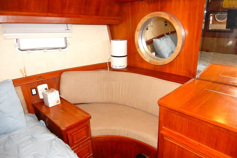  Yacht Photos Pics 1989 Jefferson 46 Sundeck interior with wooden furnishings and cozy seating area.