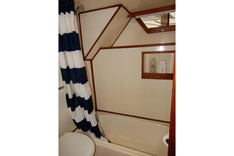  Yacht Photos Pics Bathroom interior of 1989 Jefferson 46 Sundeck yacht with striped shower curtain.