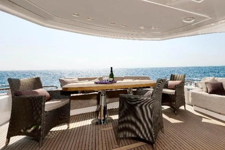 Tyche Yacht Photos Pics Luxury outdoor seating on 2019 Monte Carlo Yachts MCY 76, overlooking the ocean.