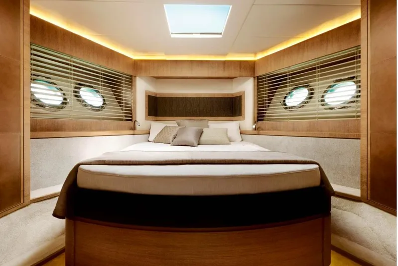 Tyche Yacht Photos Pics Luxurious bedroom interior of 2019 Monte Carlo Yachts MCY 76 with elegant wood finishes.