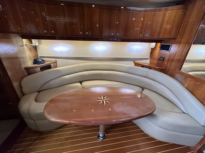  Yacht Photos Pics Luxurious interior of a 2007 Regal 4460 Commodore yacht with curved seating and wooden table.