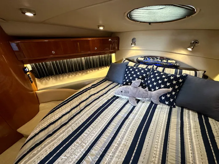  Yacht Photos Pics Luxurious bedroom in 2007 Regal 4460 Commodore yacht with plush bedding and star-themed decor.