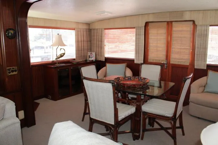 Eternity Yacht Photos Pics Interior of 1985 Hatteras 58 Motor Yacht with elegant dining area and wooden accents.
