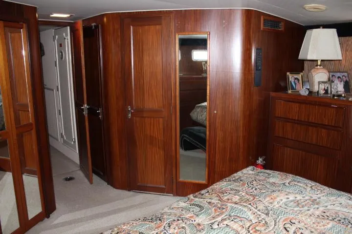 Eternity Yacht Photos Pics Interior of 1985 Hatteras 58 Motor Yacht with wood paneling and cozy bedroom.