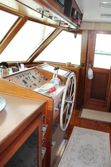 Eternity Yacht Photos Pics 1985 Hatteras 58 Motor Yacht helm with wooden accents and large steering wheel.