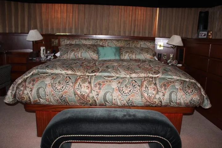 Eternity Yacht Photos Pics Luxurious bedroom interior of 1985 Hatteras 58 Motor Yacht with patterned bedding.