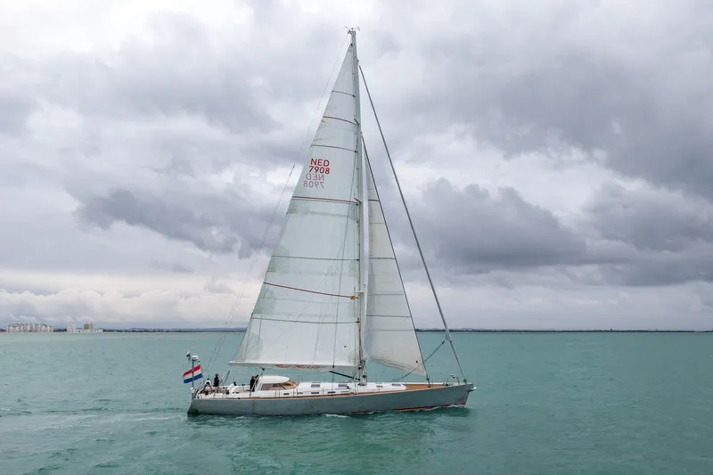 Red Rooster Yacht Photos Pics Sailing yacht Van De Stadt Stadtship 70, 2008, on calm waters under cloudy skies.