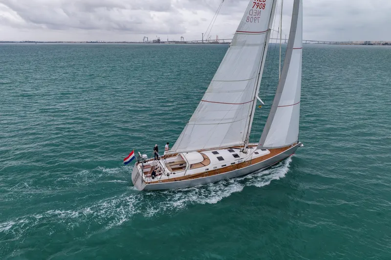 Red Rooster Yacht Photos Pics Sailing yacht Van De Stadt Stadtship 70, 2008, cruising on open water under cloudy skies.