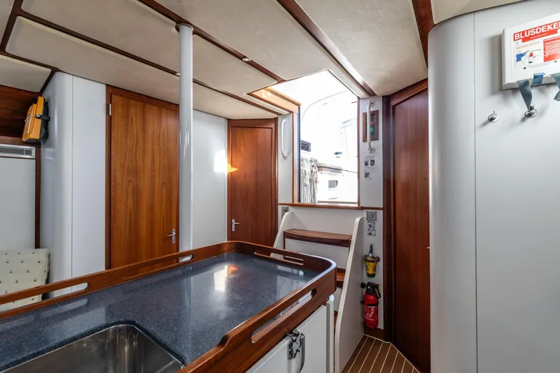 Red Rooster Yacht Photos Pics Interior of 2008 Van De Stadt Stadtship 70 yacht, featuring wood finishes and modern amenities.