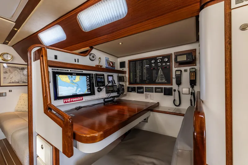 Red Rooster Yacht Photos Pics Navigation station of 2008 Van De Stadt Stadtship 70 yacht with control panels and seating.