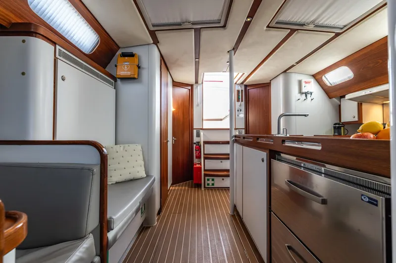 Red Rooster Yacht Photos Pics Luxurious interior of 2008 Van De Stadt Stadtship 70 yacht with modern kitchen and seating area.