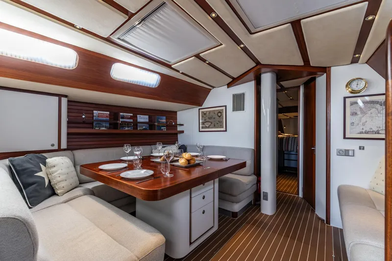 Red Rooster Yacht Photos Pics Luxurious interior of 2008 Van De Stadt Stadtship 70 yacht with elegant dining area.