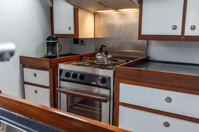 Red Rooster Yacht Photos Pics Galley kitchen in 2008 Van De Stadt Stadtship 70 yacht with stove and cabinets.