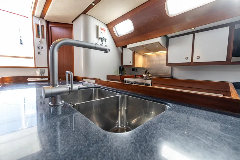 Red Rooster Yacht Photos Pics Luxurious kitchen interior of 2008 Van De Stadt Stadtship 70 yacht, featuring modern fixtures.