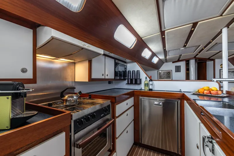 Red Rooster Yacht Photos Pics Luxurious 2008 Van De Stadt Stadtship 70 yacht kitchen with modern appliances and elegant wood finish.
