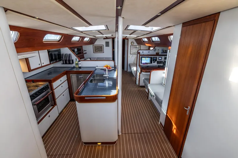 Red Rooster Yacht Photos Pics Luxurious interior of 2008 Van De Stadt Stadtship 70 yacht, featuring modern kitchen and navigation area.