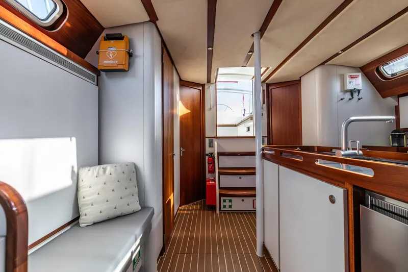 Red Rooster Yacht Photos Pics Interior of 2008 Van De Stadt Stadtship 70 yacht, featuring modern kitchen and seating area.