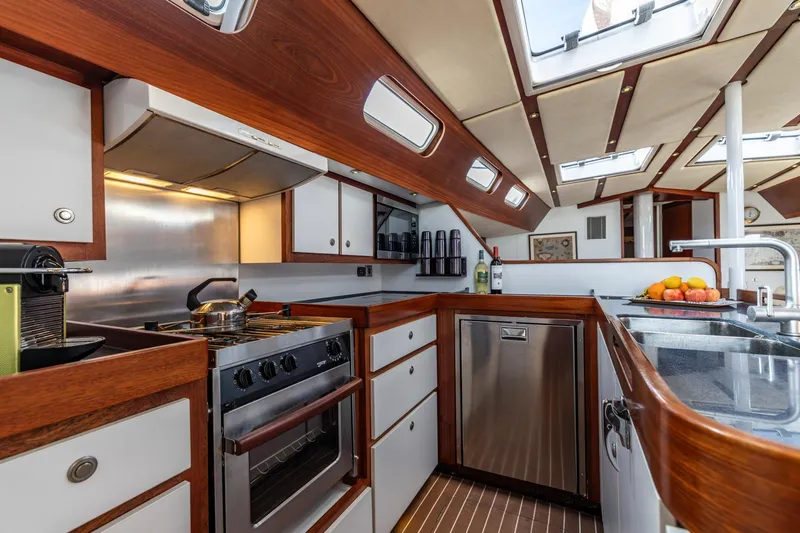 Red Rooster Yacht Photos Pics Luxurious 2008 Van De Stadt Stadtship 70 yacht kitchen with modern appliances and elegant wood finish.